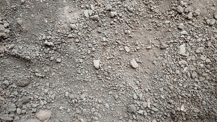 The ground surface is small rocks and dry gray gravel, with a rough and uneven texture © Hilal