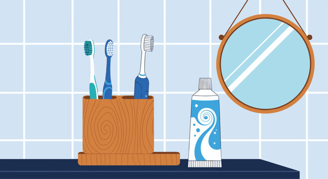 Clean bathroom counter setup featuring multiple toothbrushes toothpaste and a round mirror against a blue tiled wall.
