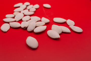 Whole Pumpkin Seeds in Shell Isolated, Raw Pepita Grains, Scattered Green Healthy Nuts, Pumpkin Seed with Skin on White Background Top View