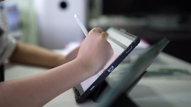 closeup tablet and hand of young child study online or kid student write learning on computer laptop by touch pen and touch screen with doing homework or people writing to learn from home school
