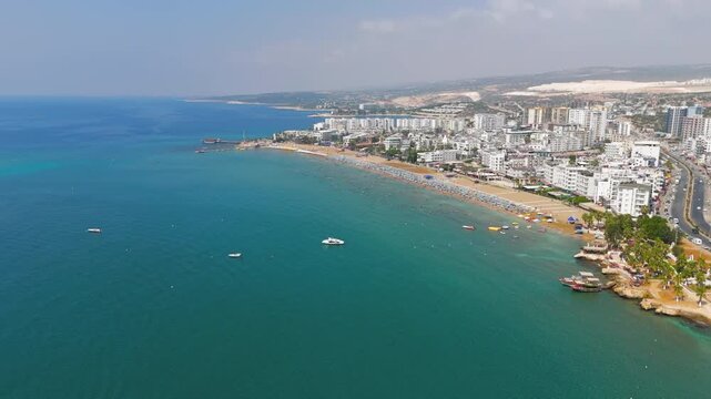 Kizkalesi, Mersin, Turkey. Scenic beach with umbrellas and Maiden Castle island view, aerial perspective of Korykos Castle on coastline.. Aerial View, Departure of the camera