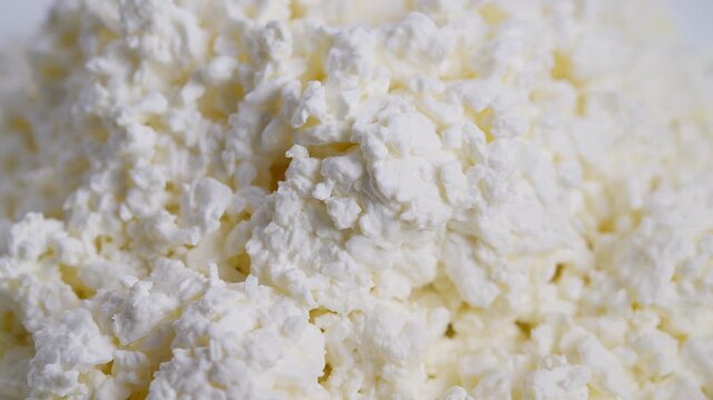Texture of fresh dairy curds revealed, Macro view showcasing soft white cheese granules, Natural farmhouse style display of moist dairy curds with nutritious benefits