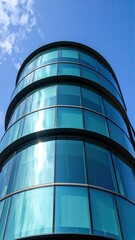 Modern curved glass facade of a high-rise office building reflecting blue sky and clouds showcasing contemporary architecture design and urban landscape