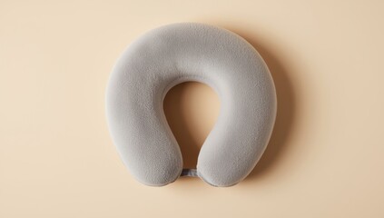 overhead shot of plush travel neck pillow on beige surface