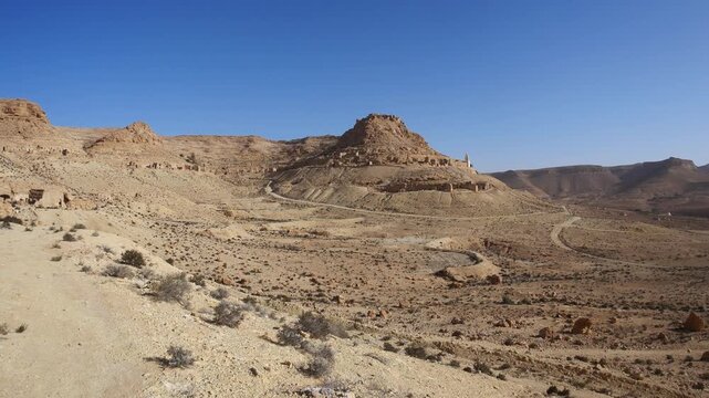 Panorama: Ancient Ksar Douiret in southern Tunisia, featuring traditional Berber mudbrick granaries and arched storage rooms, showcasing Saharan architecture, history, and cultural heritage