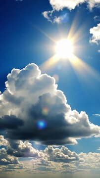 Bright sun shines through clouds in the afternoon sky over the landscape