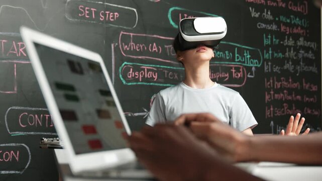 Closeup of african student hands coding or programming system at blackboard with web develop plan while young girl playing in metaworld at blackboard with engineering prompt. Innovation. Edification