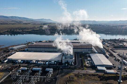 Aerial drone picture of a large data center campus with cooling steam, electrical substation along the Columbia River in The Dalles, Oregon, USA. Power demand for cloud computing AI infrastructure