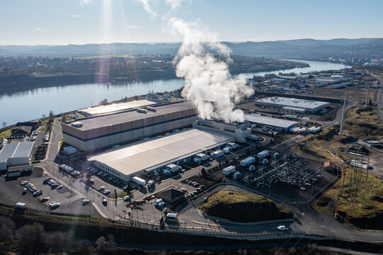 Aerial drone picture of a large data center campus with cooling steam, electrical substation along the Columbia River in The Dalles, Oregon, USA. Power demand for cloud computing AI infrastructure