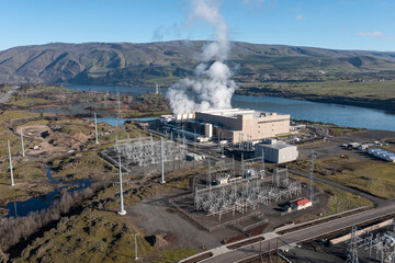 Aerial drone picture of a large data center campus with cooling steam, electrical substation along the Columbia River in The Dalles, Oregon, USA. Power demand for cloud computing AI infrastructure © Hrach