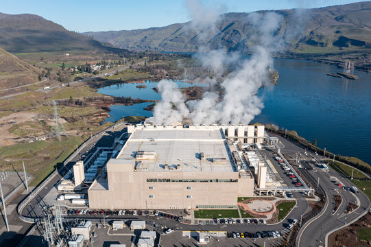 Aerial drone picture of a large data center campus with cooling steam, electrical substation along the Columbia River in The Dalles, Oregon, USA. Power demand for cloud computing AI infrastructure