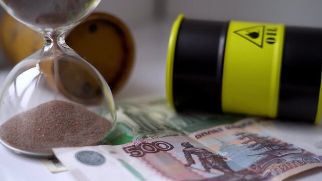 Russian money and an oil barrel with an hourglass