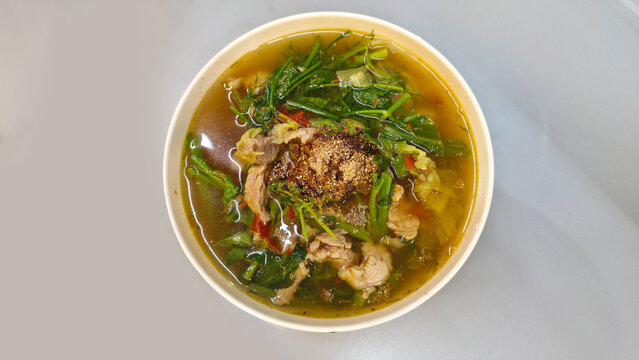 Traditional Thai Isan beef herb soup called Gaeng Om Nuea made with beef, fresh herbs, chili and vegetables in a spicy aromatic broth