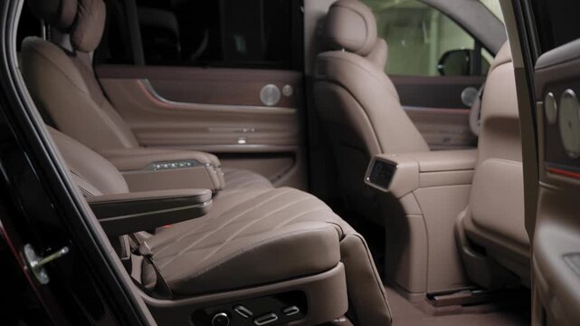 Interior of a passenger car with beige leather seats. 