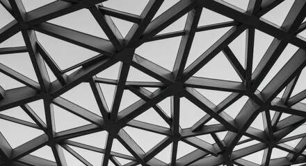 Fototapeta premium A close-up view of a futuristic structure's complex network of interconnected black beams and panels