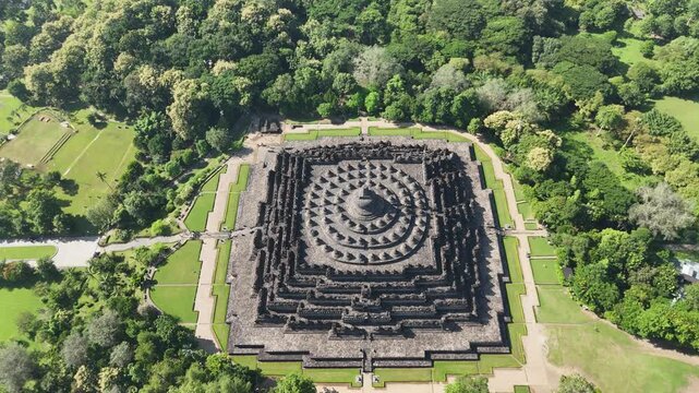 Cinematic aerial top-down view of Borobudur temple mandala architecture, sacred Buddhist site, Central Java, Indonesia