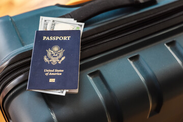 US passport with dollar banknotes on travel suitcase symbolizing international travel and money