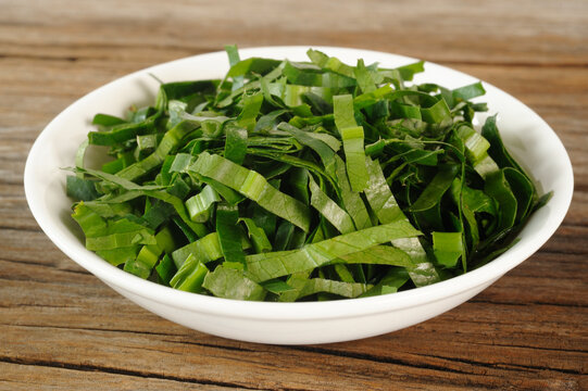 Fresh chopped culantro in white bowl