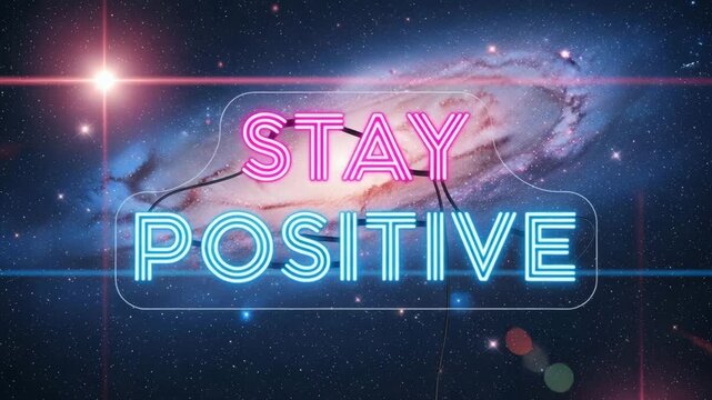 The phrase 'STAY POSITIVE' is illuminated in neon lights against the backdrop of a breathtaking galaxy and cosmic nebula.