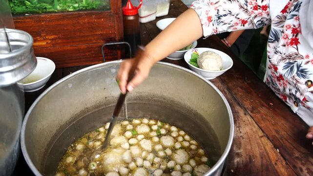 Bakso or baso is an Indonesian meatball, or a meat paste made from beef surimi. Its texture is similar to the Chinese beef ball, fish ball, or pork ball. a meatball stall vendor who prepares a bowl.