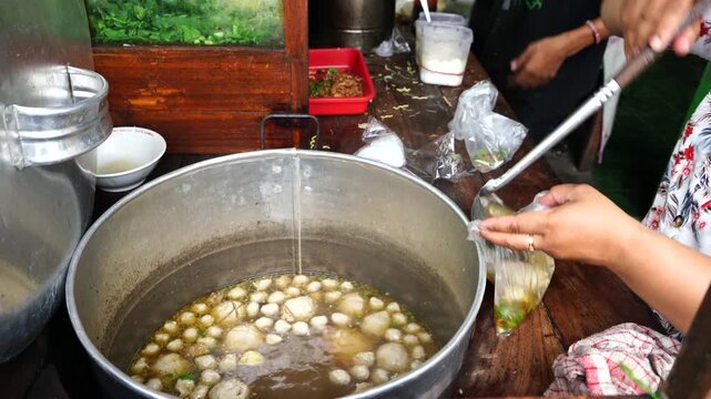 Bakso or baso is an Indonesian meatball, or a meat paste made from beef surimi. Its texture is similar to the Chinese beef ball, fish ball, or pork ball. a meatball stall vendor who prepares a bowl.