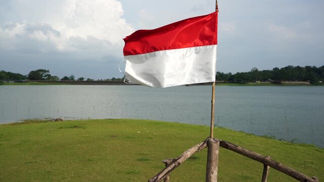 The single large red and white Indonesian flag flutters in the strong wind ahead of the 81th Independence Day of the Republic of Indonesia.