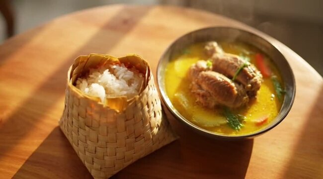 Traditional chicken soup and rice served on wooden table