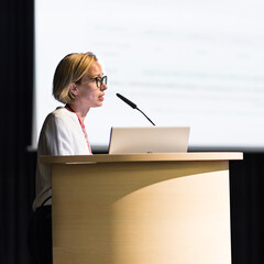 Female speaker giving a talk on corporate business conference. Business and Entrepreneurship event
