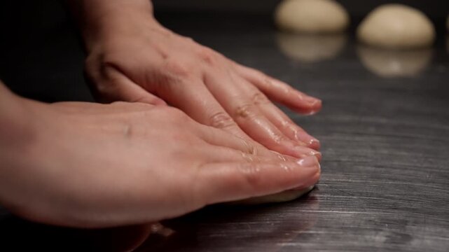 Close-up sequence of raw dough ball gradually flattening on metal surface, highlighting texture transformation during early bread or pastry preparation stages