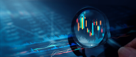 Magnifying glass over candlestick chart and digital financial diagram, Stock market data analysis...