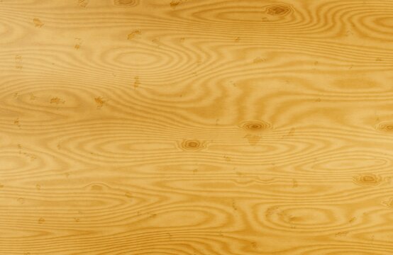 Smooth yellow pine wood board texture with natural wavy grain patterns.