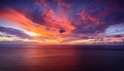 Fototapeta premium Majestic Sunset Over A Tranquil Ocean Featuring A Vibrant And Dramatic Cloudscape Painting The Sky With Brilliant Orange Yellow And Pink Hues A Serene Natural Landscape At Dusk