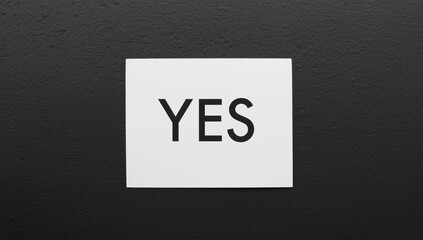 Note saying YES on a black board