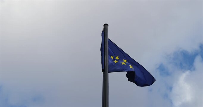 European Union flag waving against a cloudy sky
