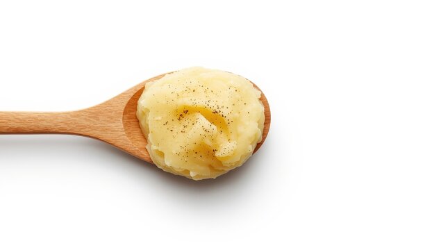 Top view of a wooden spoon with delicious mashed potatoes on a white background