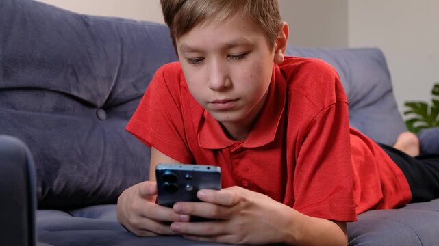 12 Year Old Teenage Boy Using Smartphone at Home