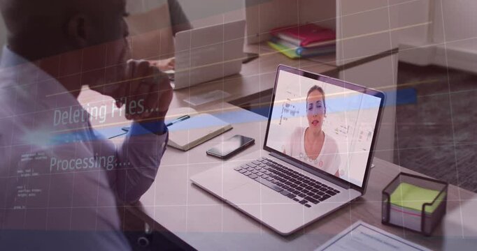 Processing overlay appearing, fading, presenter on laptop gesturing while man reviewing biz notes
