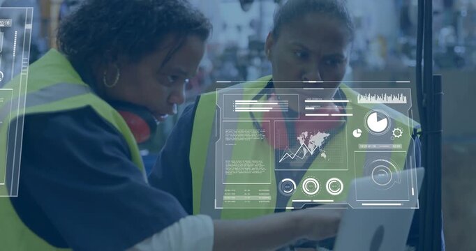 Two technicians exchanging scanner while reviewing overlaid analytics on laptop for warehouse fix