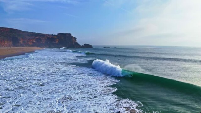 Aerial drone view of the dramatic Atlantic Ocean coastline near Cabo da Roca and Nazare in Portugal. Scenic rocky cliffs, powerful ocean waves and beautiful coastal landscape during sunset golden hour