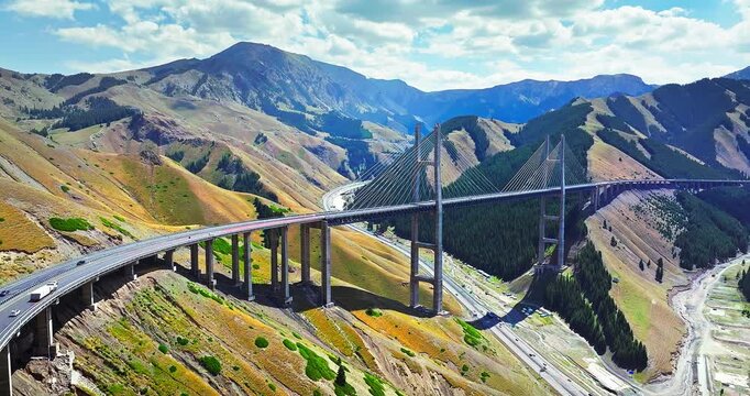 Aerial view of Guozigou cable-stayed bridge spanning a mountain valley in Xinjiang, China.