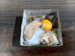 Assortment of Snacks in a Takeout Box. Lunch Box Meal with Rice and Side Dishes.