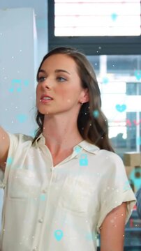 Vertical video: Woman reaching pinning doc to board stepping back scanning biz AR icons overlaying