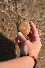 a stone with the inscription love in hand