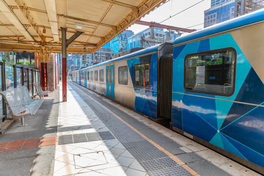 Sunday 8 March 2026 Train on Flinders Station on Yarra River walkway in Melbourne CBD surrounded by High rise residential and commecial building offices in autumn Melbourne CBD VIC Australia