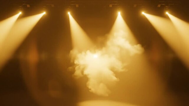 Dramatic theatrical stage with bright golden spotlights and billowing smoke for an exciting performance or concert