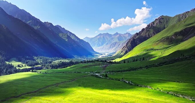 Aerial view of lush green alpine meadows and mountain valleys in the Tianshan Mountains, Xinjiang, China.