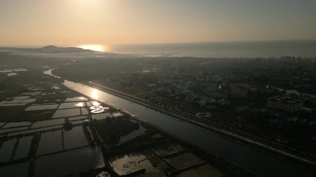 Drone aerial sunset over river and city landscape in Phan Thiet Vietnam