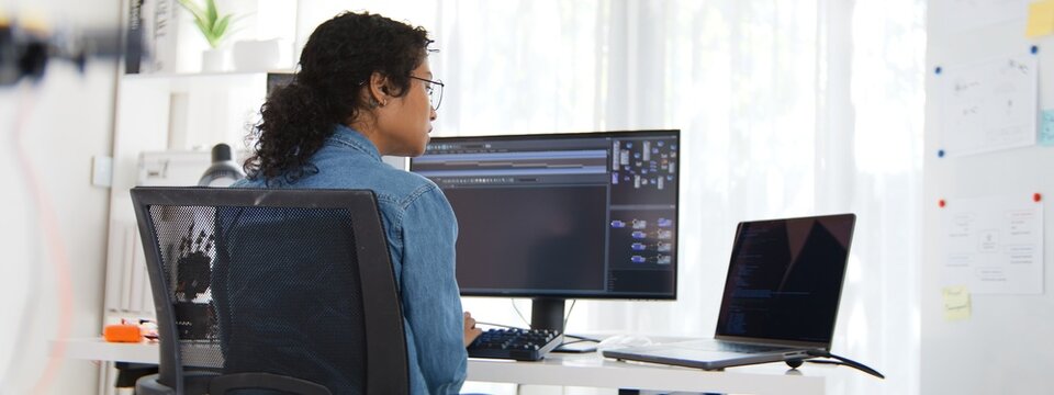 Asian female software engineer developer woman use laptop computer work on coding at home office. Professional freelance programmer job. Internet technology, Work from home concept