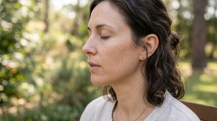 Fototapeta premium woman with closed eyes sitting in a natural outdoor setting