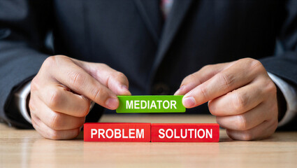 Hands placing mediator block between problem and solution blocks